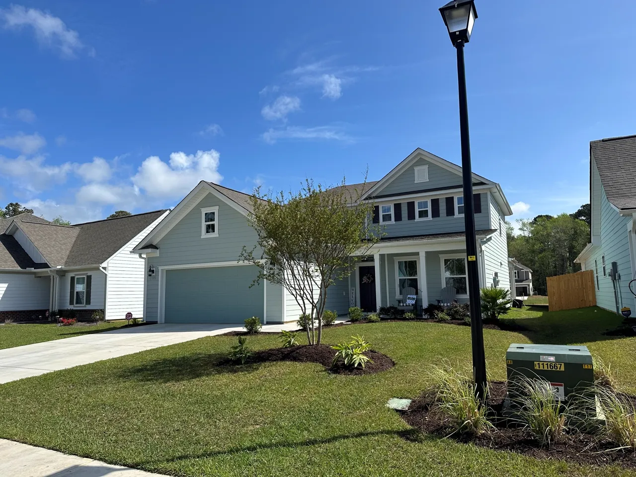 Rock bed around a lamp post and mailbox, tidy front-yard curb appeal.