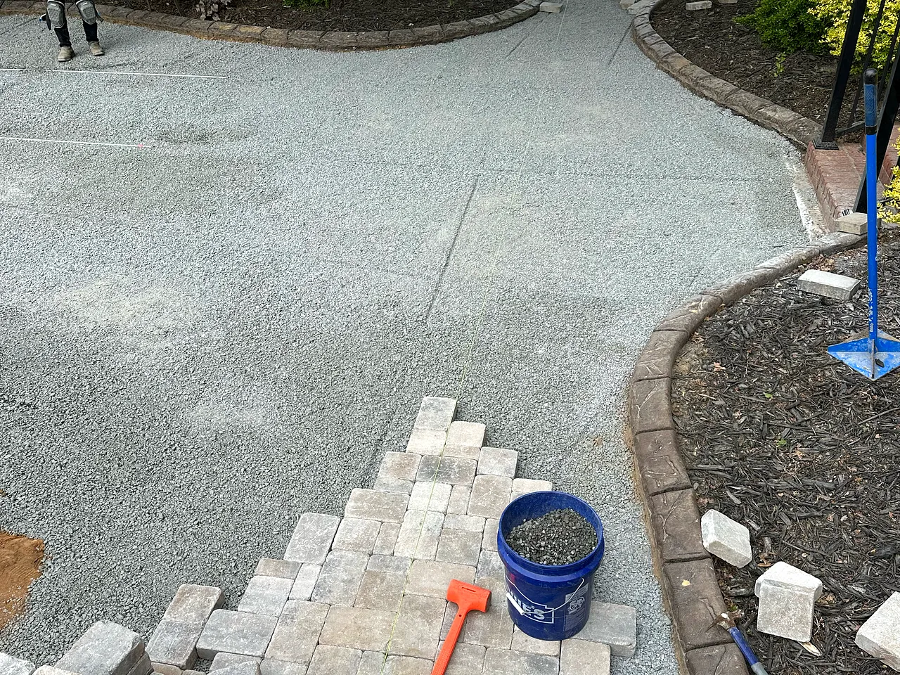Paver patio and fire-pit build, joints set tight and edges clean.